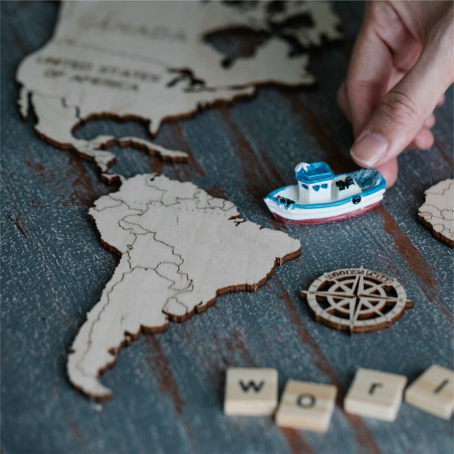 cardboard world map with toy ship